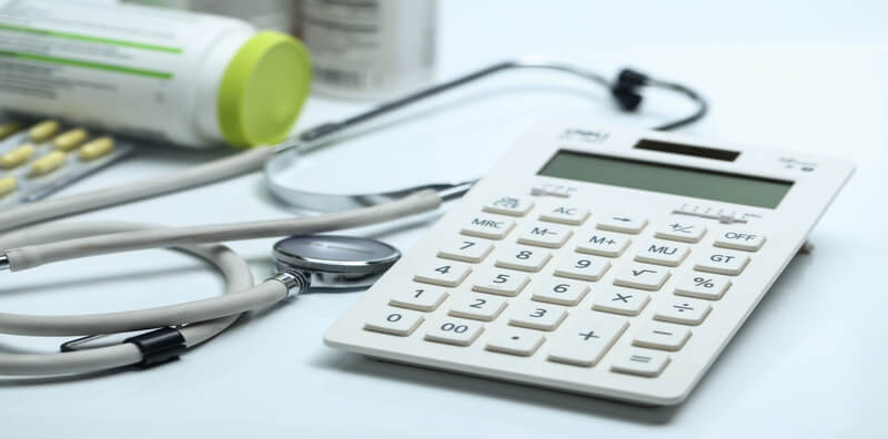 calculator-stethoscope-medicine-bottles-white-background_800x396-op